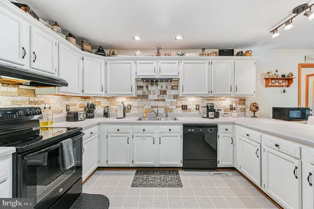 a kitchen with cabinets appliances and a sink