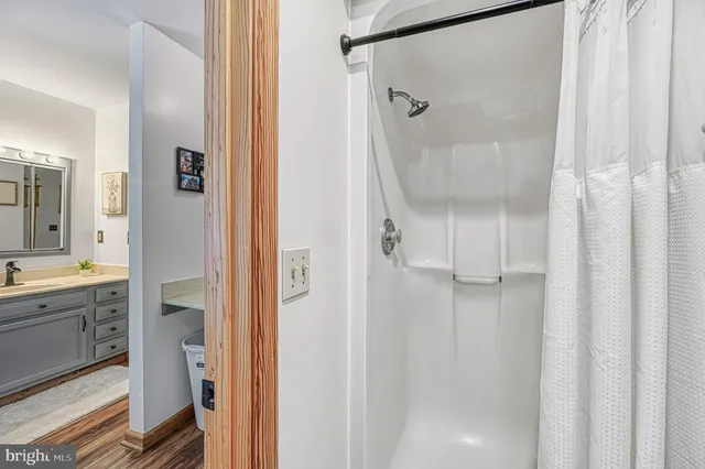 a bathroom with a granite countertop shower mirror and a sink