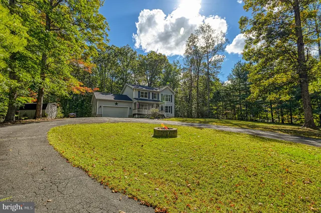 a view of a swimming pool with an outdoor seating and a yard