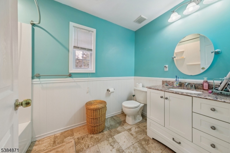 47 Thomas Street Monroe Township, NJ 08831 - Photo 14 of 19 a bathroom with a granite countertop toilet sink mirror and vanity