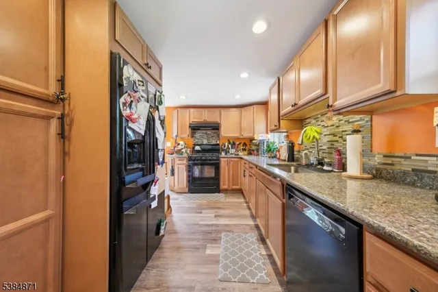 a kitchen with stainless steel appliances granite countertop a refrigerator and a sink