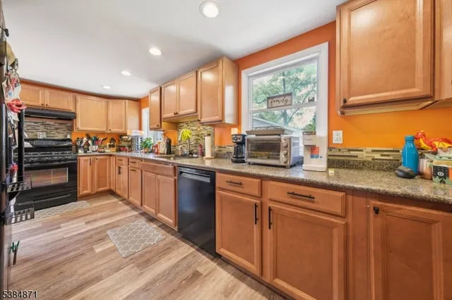a kitchen with stainless steel appliances granite countertop a stove sink and cabinets