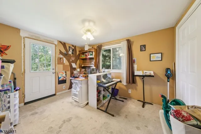 a view of a workspace with furniture and a window