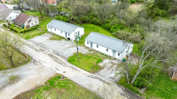an aerial view of a house with a garden and trees