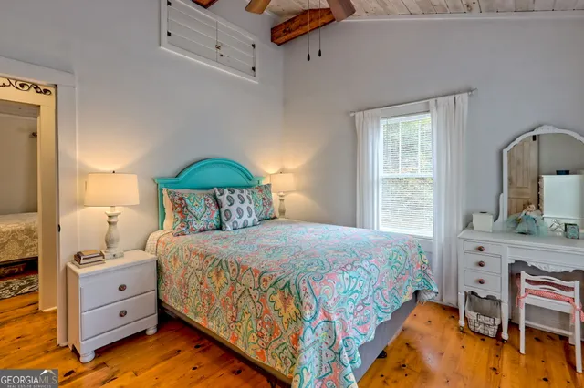 a bedroom with a bed and a dresser in it