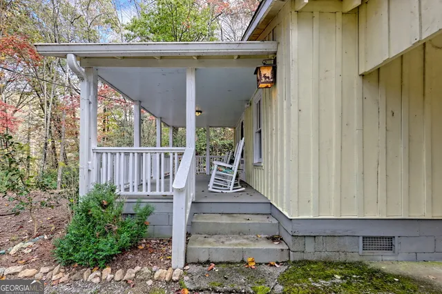 a view of a balcony with wooden floor and plants