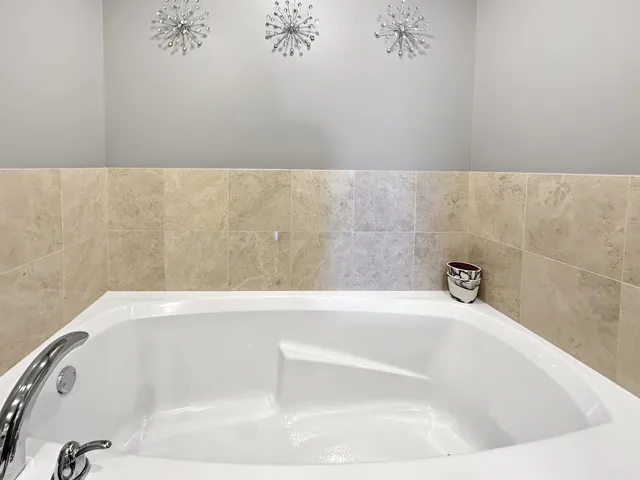 a view of a hallway with wooden floor and furniture