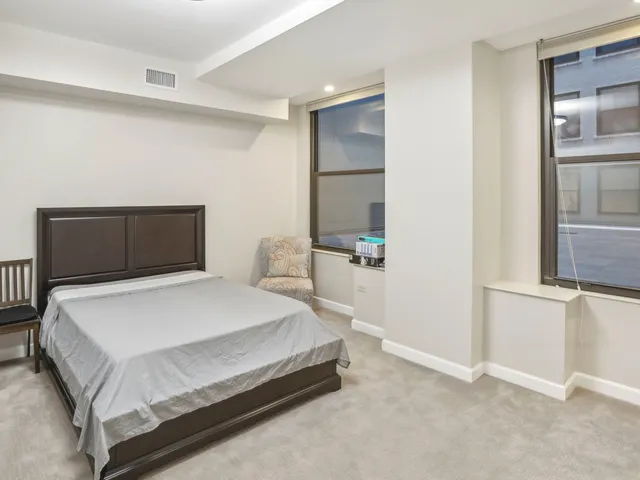 a bedroom with a bed and a couch