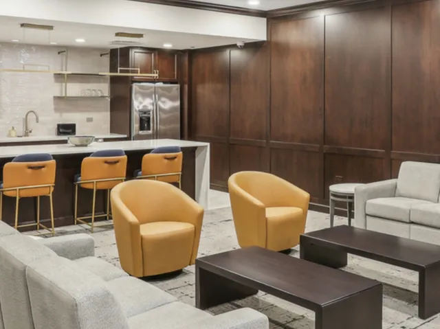 a large white kitchen with a sink and refrigerator