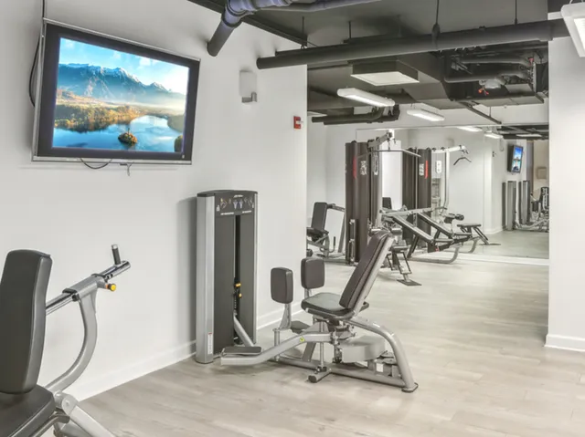a living room with hardwood floor and a large window