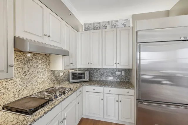 a kitchen with white cabinets and white appliances
