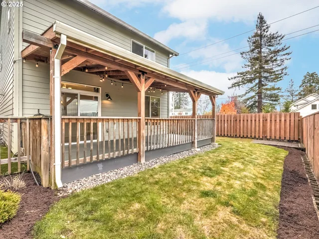 a view of a house with wooden fence and a large window