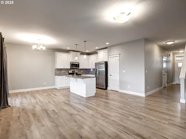 a view of kitchen refrigerator and microwave