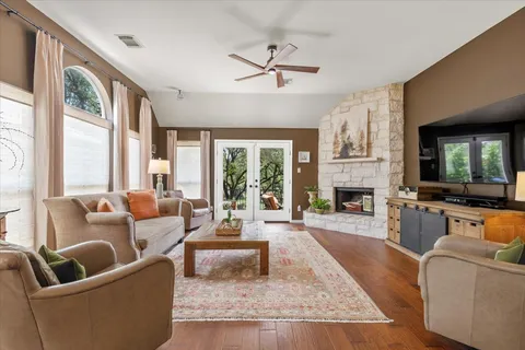 a living room with furniture fireplace and a large window