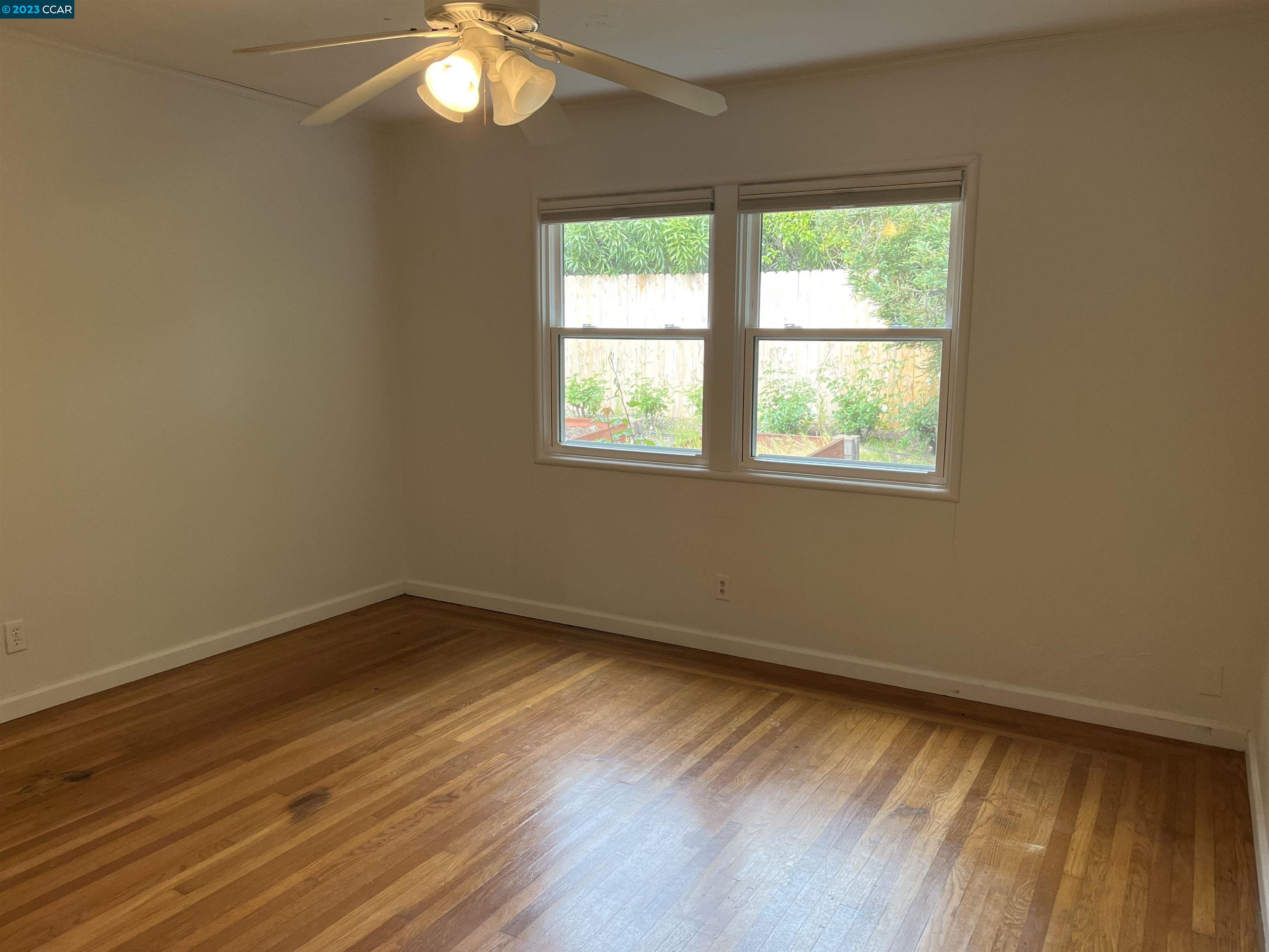 3524 Oliver Court Lafayette, CA 94549 - Photo 13 of 32 a view of an empty room with wooden floor and a window
