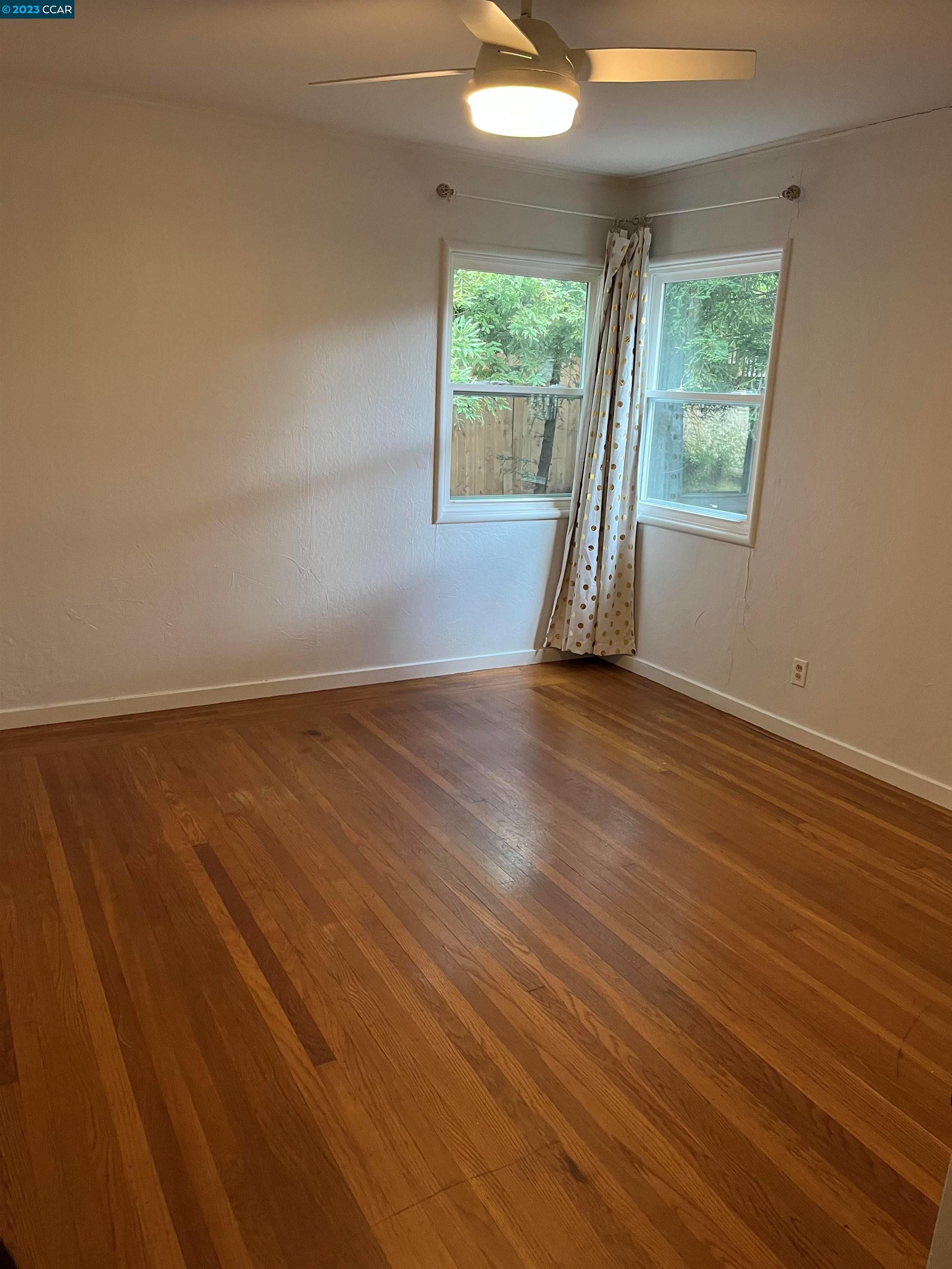 3524 Oliver Court Lafayette, CA 94549 - Photo 14 of 32 an empty room with wooden floor and windows