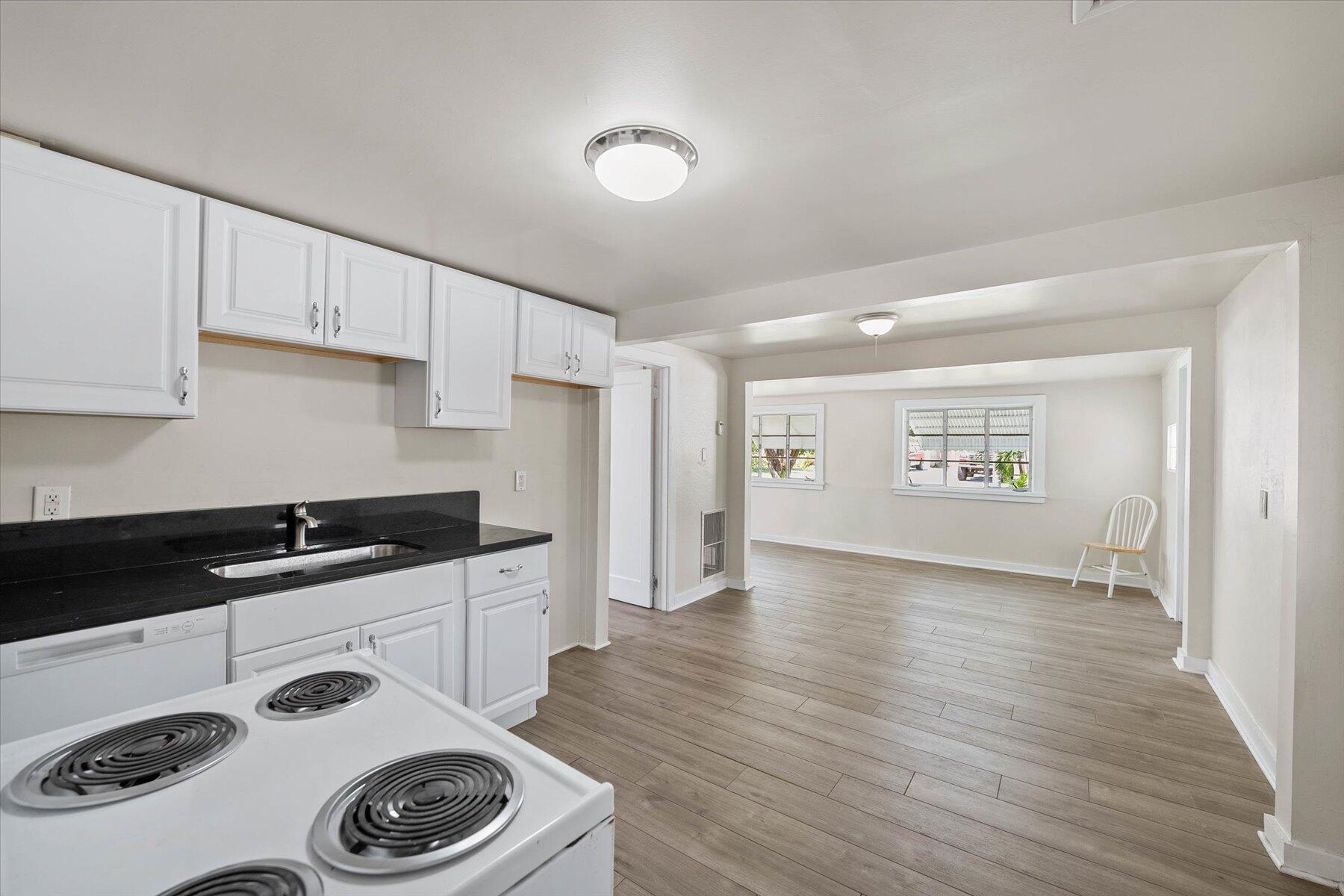 7936 Terrace Road Lantana, FL 33462 - Photo 13 of 25 a kitchen with a sink a stove and cabinets
