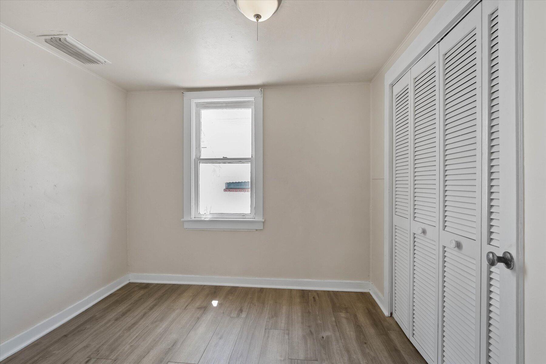 7936 Terrace Road Lantana, FL 33462 - Photo 15 of 25 a view of an empty room with wooden floor and a window