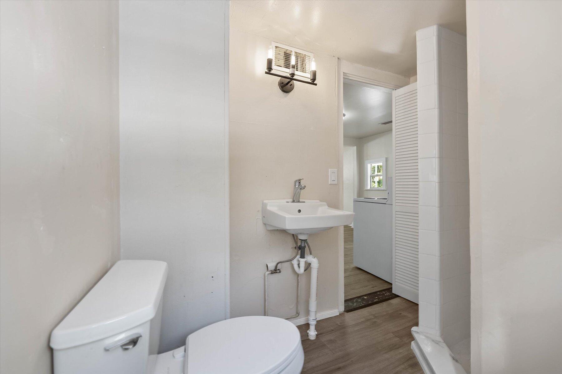 7936 Terrace Road Lantana, FL 33462 - Photo 17 of 25 a bathroom with a toilet sink and mirror