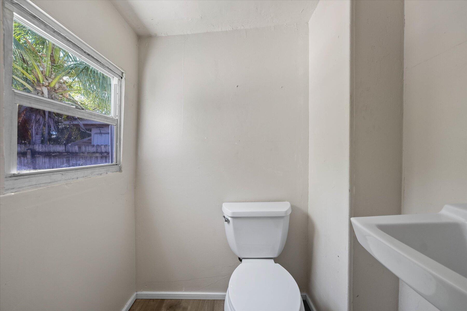 7936 Terrace Road Lantana, FL 33462 - Photo 18 of 25 a bathroom with a toilet and a sink