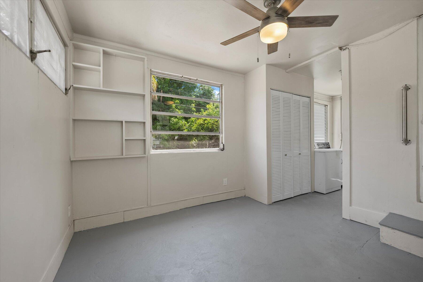 7936 Terrace Road Lantana, FL 33462 - Photo 20 of 25 an empty room with a window and a ceiling fan