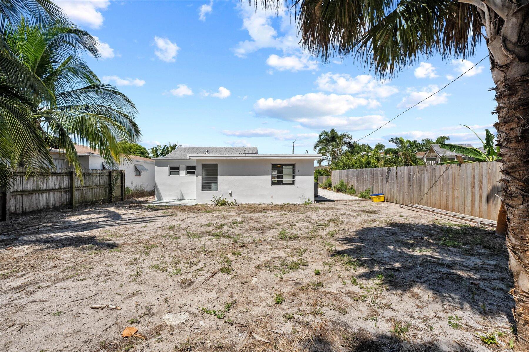 7936 Terrace Road Lantana, FL 33462 - Photo 24 of 25 a backyard of a house with table and chairs