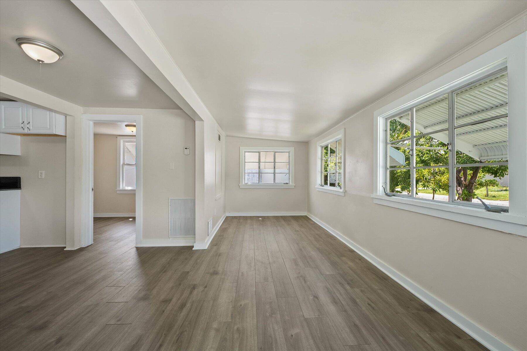 7936 Terrace Road Lantana, FL 33462 - Photo 6 of 25 a view of an empty room with wooden floor and a window