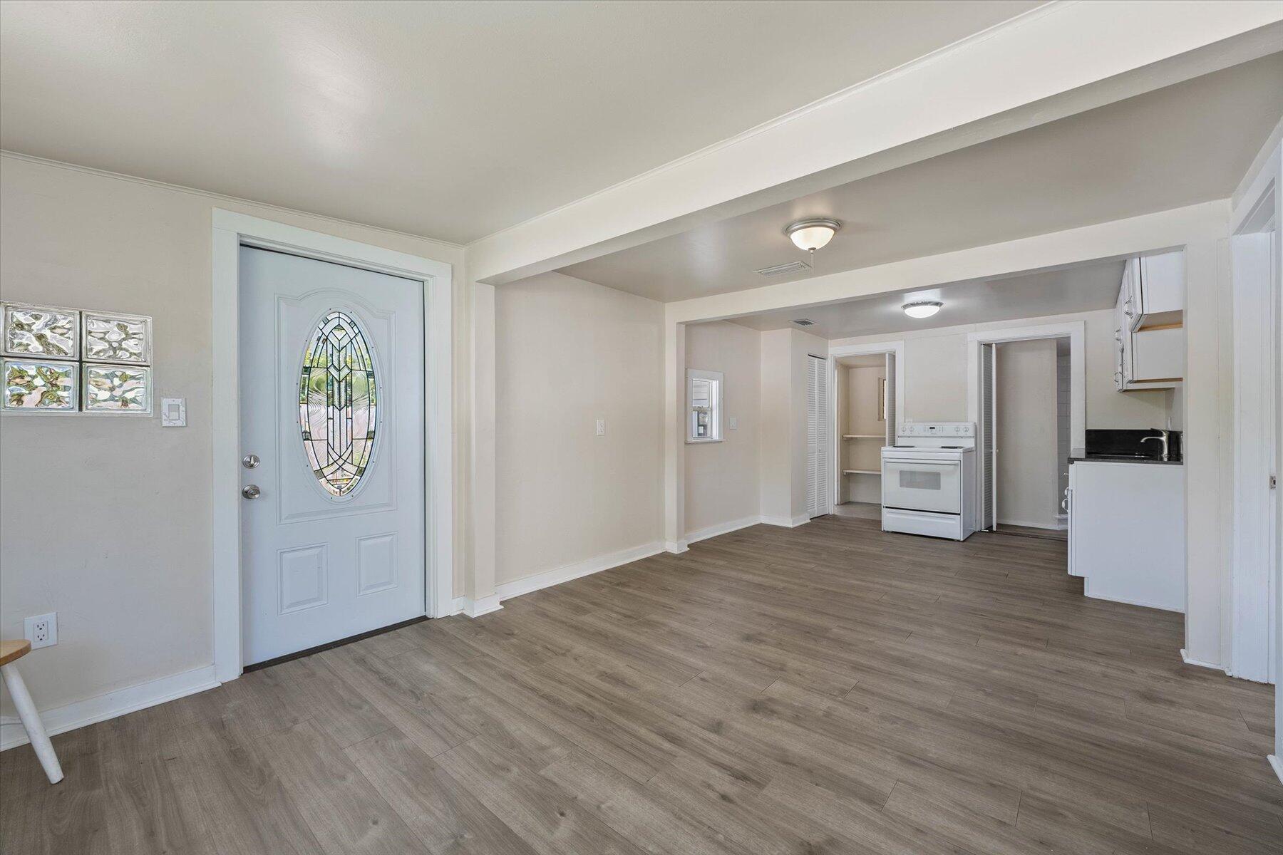 7936 Terrace Road Lantana, FL 33462 - Photo 10 of 25 a view of an empty room with wooden floor and a window