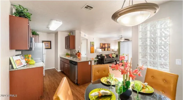 a very nice looking dining room with kitchen island furniture and a chandelier