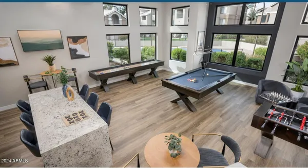 a view of a patio with couches table and chairs under an umbrella