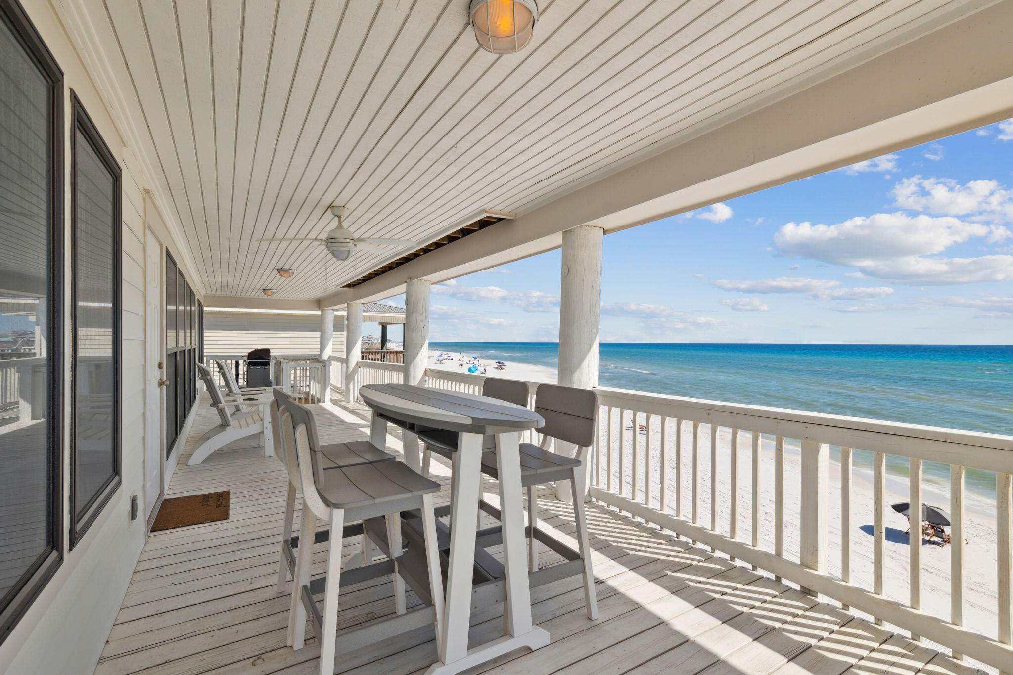 103 Fort Panic Road Santa Rosa Beach, FL 32459 - Photo 13 of 60 a view of a patio with table and chairs with wooden floor and fence