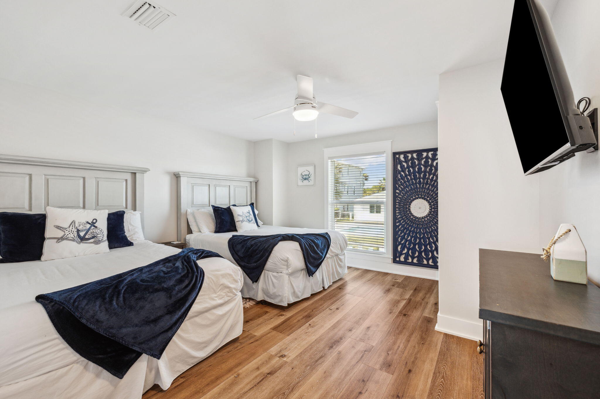 103 Fort Panic Road Santa Rosa Beach, FL 32459 - Photo 15 of 60 a spacious bedroom with a bed a flat screen tv and dresser