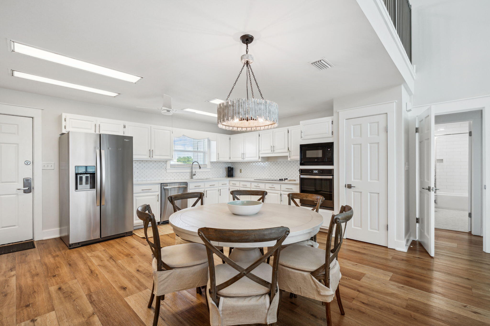 103 Fort Panic Road Santa Rosa Beach, FL 32459 - Photo 24 of 60 a view of a dining room with furniture wooden floor and chandelier