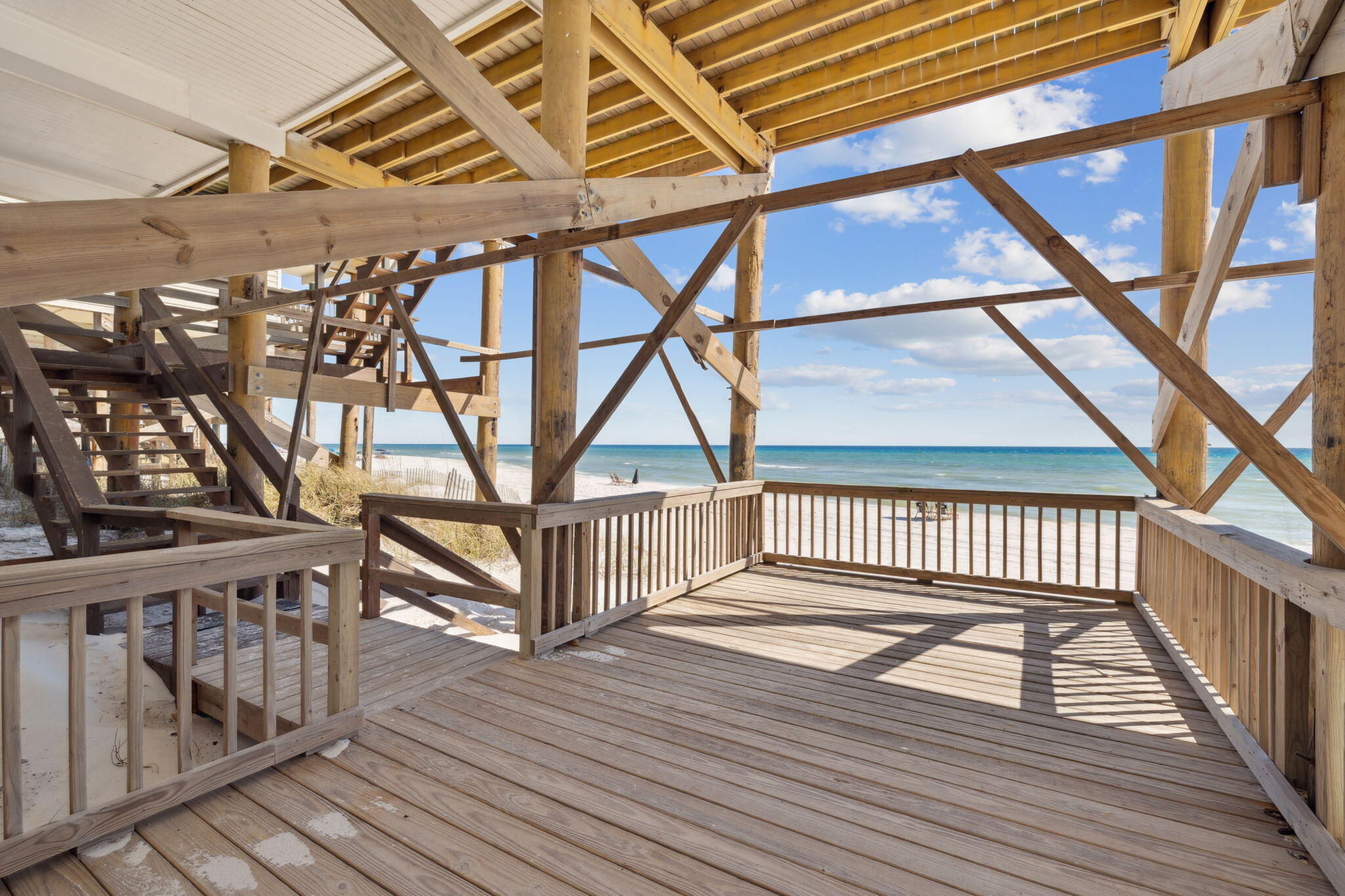 103 Fort Panic Road Santa Rosa Beach, FL 32459 - Photo 32 of 60 a view of staircase with lots of frames on wall and a wooden floor
