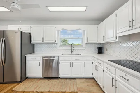 a bathroom with a double vanity sink toilet mirror and shower