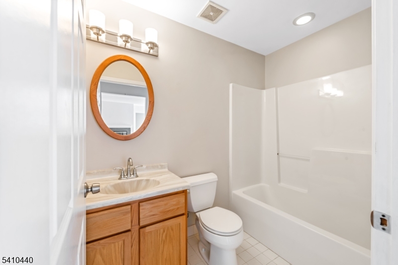 90 Crestview Lane Mount Arlington, NJ 07856 - Photo 14 of 15 a bathroom with a sink a toilet and a mirror