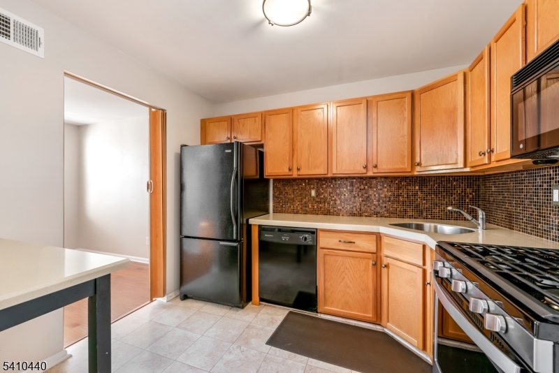 90 Crestview Lane Mount Arlington, NJ 07856 - Photo 9 of 15 a kitchen with stainless steel appliances granite countertop a refrigerator stove and sink