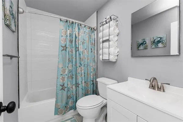 a white toilet sitting next to a bathroom sink