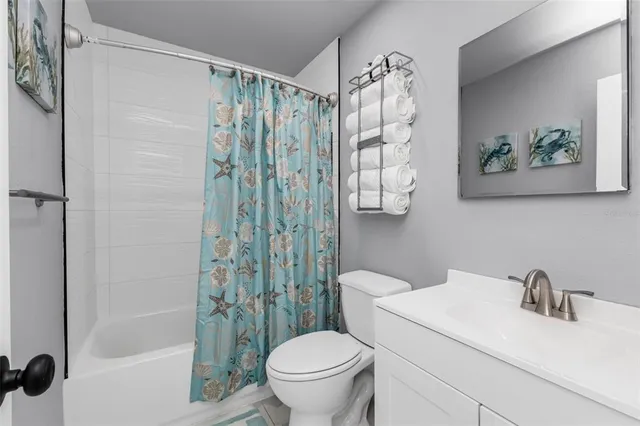a white toilet sitting next to a bathroom sink