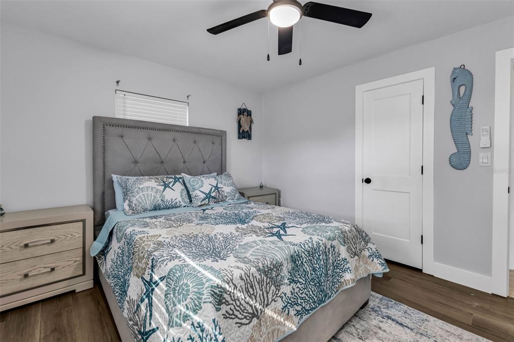 4319 Eaglet Road Punta Gorda, FL 33980 - Photo 13 of 22 a bedroom with a bed and a chandelier