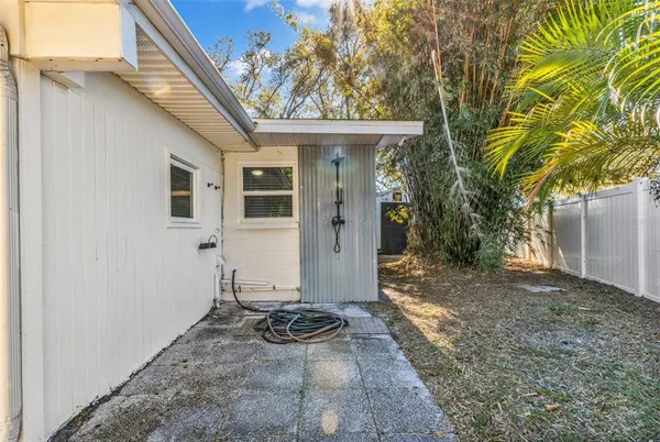 a view of a house with backyard and sitting area