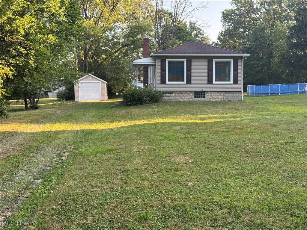 View of yard with an outbuilding and view of scattered trees