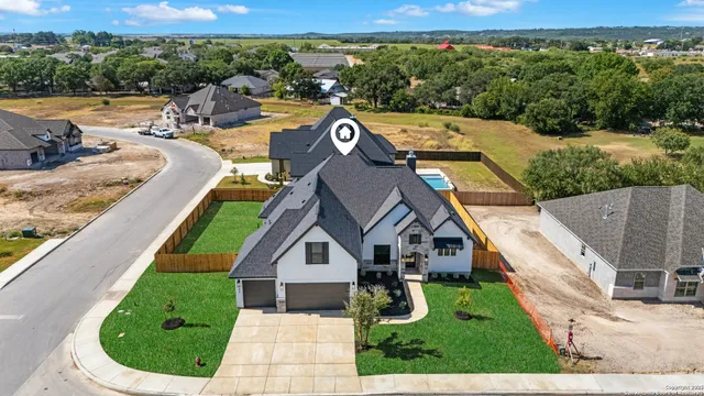 an aerial view of a house with swimming pool
