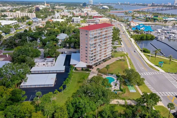 an aerial view of residential houses with outdoor space and swimming pool