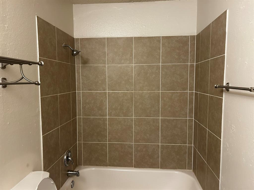 2200 East Trinity Mills Road, Unit 301 Carrollton, TX 75006 - Photo 13 of 16 a bathroom with a shower
