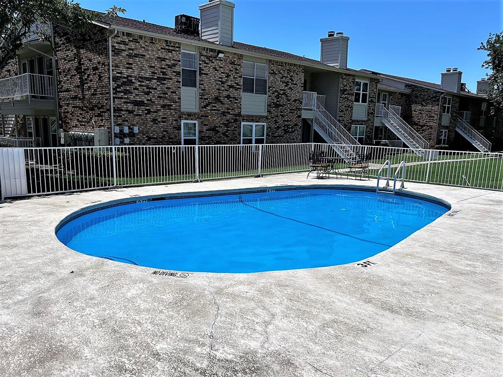 2200 East Trinity Mills Road, Unit 301 Carrollton, TX 75006 - Photo 2 of 16 a view of a swimming pool with a roof deck