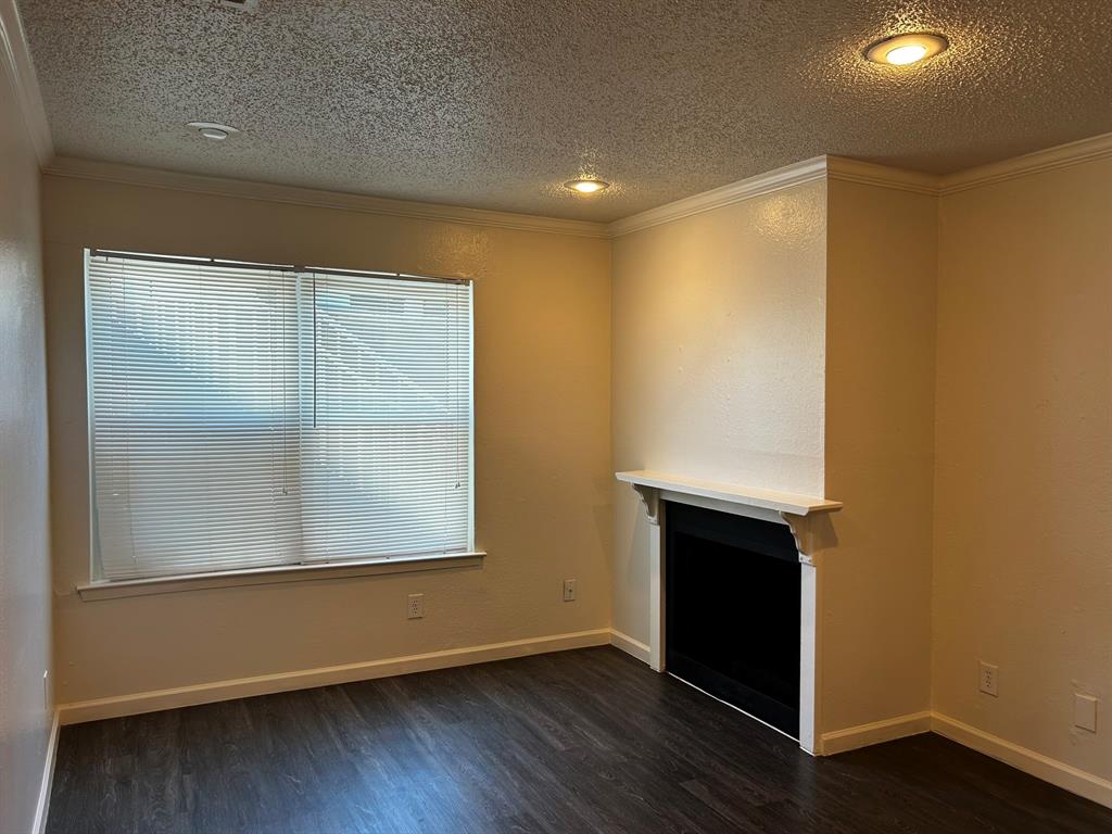 2200 East Trinity Mills Road, Unit 301 Carrollton, TX 75006 - Photo 5 of 16 an empty room with wooden floor and windows