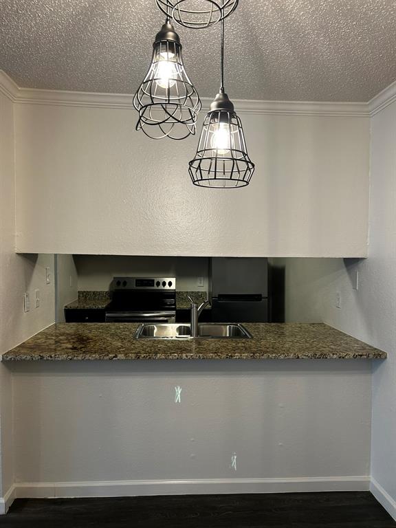 2200 East Trinity Mills Road, Unit 301 Carrollton, TX 75006 - Photo 7 of 16 a view of kitchen with stainless steel appliances granite countertop stove top oven and cabinets