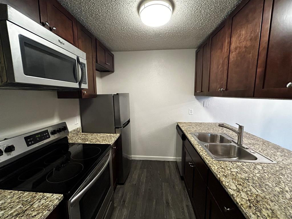 2200 East Trinity Mills Road, Unit 301 Carrollton, TX 75006 - Photo 8 of 16 a kitchen with a sink and steel appliances