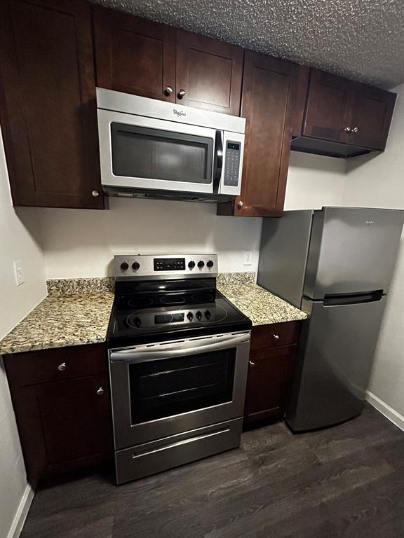 2200 East Trinity Mills Road, Unit 301 Carrollton, TX 75006 - Photo 10 of 16 a kitchen with granite countertop a sink and a stove top oven